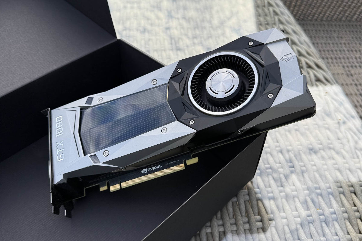 Graphics card on a black surface with a blurred outdoor background