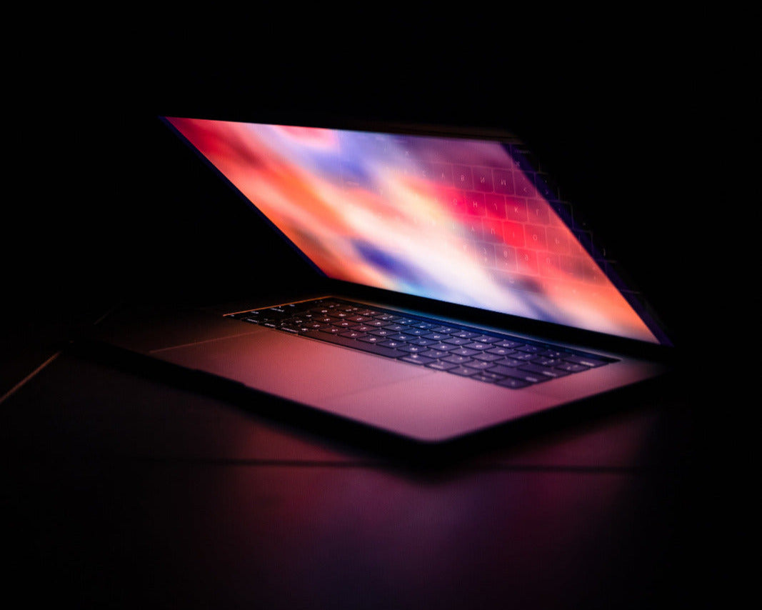 Open laptop with colorful screen on a dark background